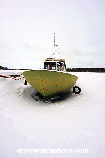 Boat on frozen lake, Lapland, Finland