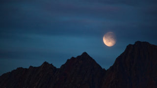 Moon rising over mountains in Nugatsiaq, Baffin Bay, Greenland