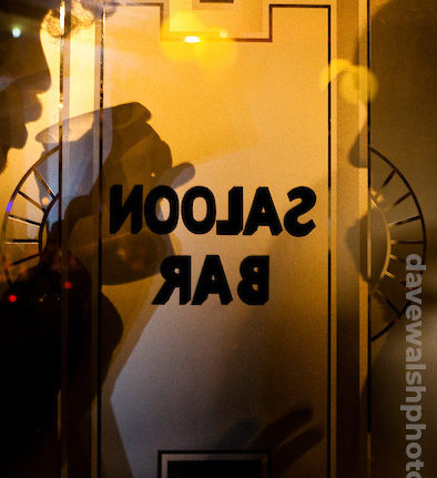 Silhouette of drinkers through bar window