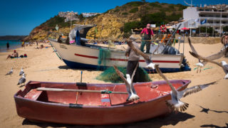 Fishermen cleaning nets in Salema